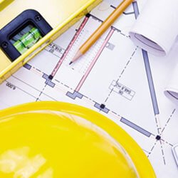 Construction planning blueprints and hard hat